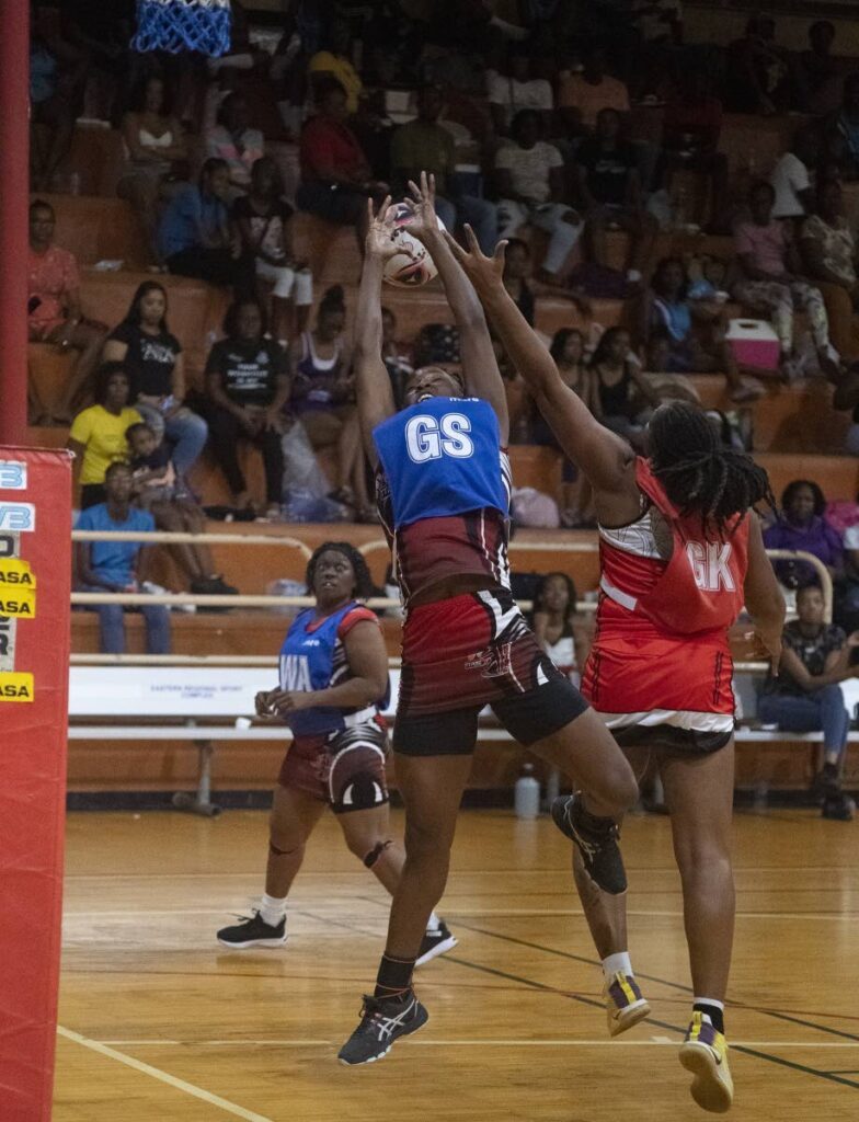 TTPost goal shooter Nekesha Gomes, left, vies for the ball with UTC Sparks goal keeper on Saturday in the Courts All Sectors Netball knockout competition, at Eastern Regional Indoor Arena, Tacarigua. - Dennis Allen for @TTgameplan