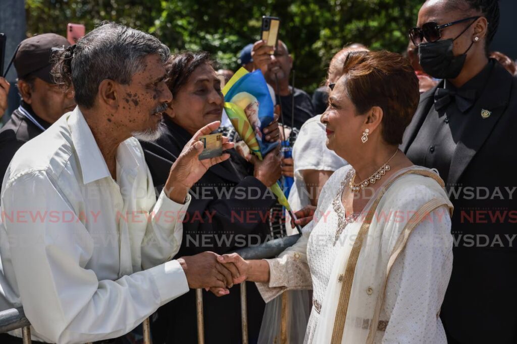 Opposition leader Kamla Persad-Bissessar greets mourners upon her arrival at the Shore of Peace Cremation Site, Mosquito Creek on January 9 - Photo by Jeff K. Mayers