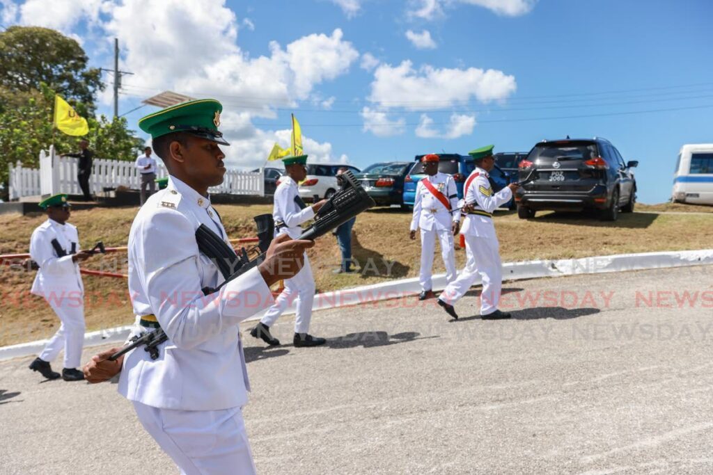 HONOURED: Defence Force officers in a solemn march towards Mosquito Creek and the Shore of Peace, where the body of former prime minister Basdeo Panday was cremated according to Hindu rites on Tuesday. - Photo by Jeff K Mayers