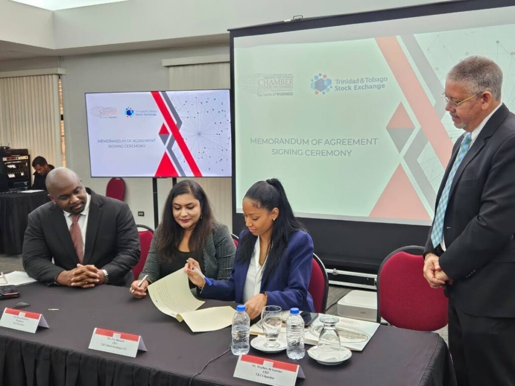 Minister in the Finance Ministry Brian Manning, left, witnessed the MOU signing between TTCIC president Kiran Maharaj, centre, and TTSE CEO Eva Mitchell, right, on January 5. - 