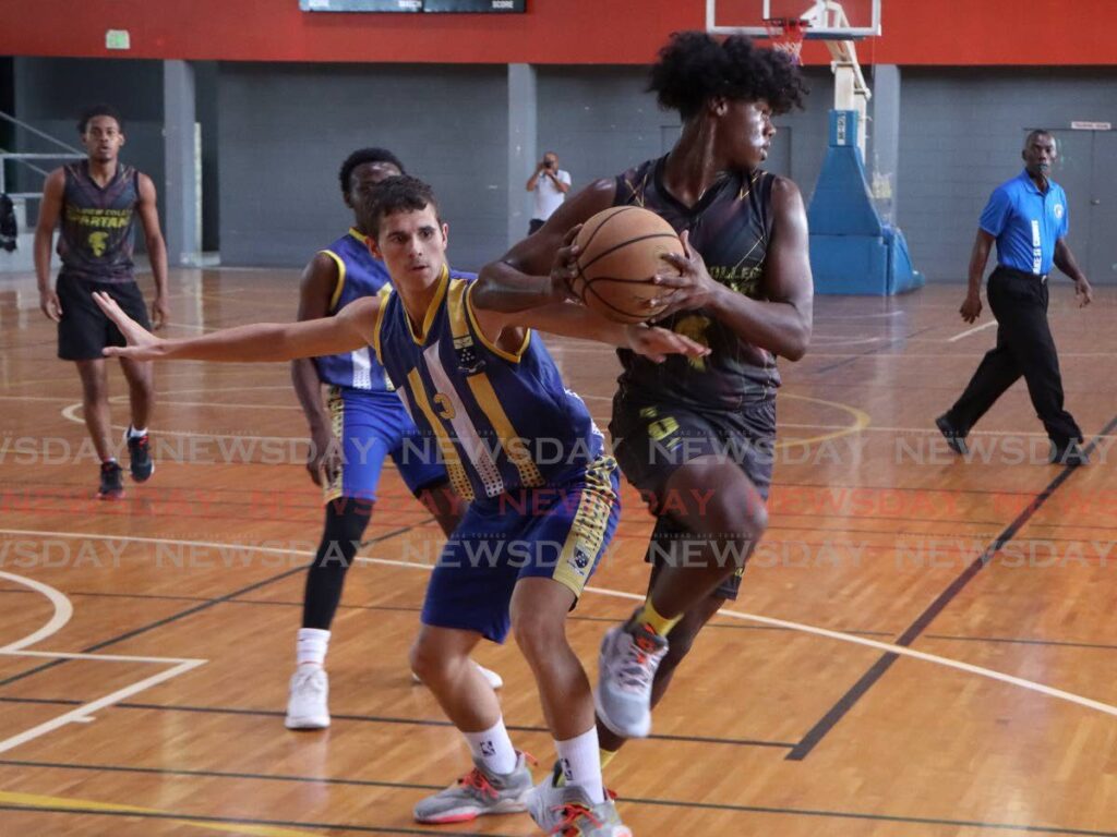 Samuel Edwards of Hillview College protects the ball as Fatima’s Jeremiah Henriques-Brown (L) defends, during the Group A knockout game at the opening of the TT Schools’ Basketball Association 2024 season, at the Maloney Indoor Facilty  - Photo by Angelo Marcelle