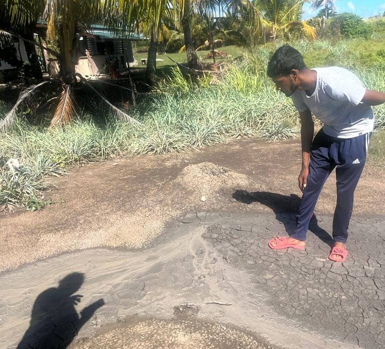 A villager takes a closer look at one of the fissures of the mud volcano at Cascadoux Trace, Mayaro during a site visit by officials of Mayaro/Rio Claro Regional Corporation on January 12.  - Photo courtesy Raymond Cozier