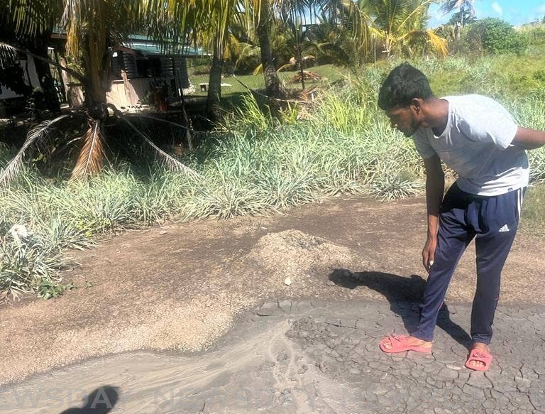 A villager takes a closer look at one of the vents of the mud volcano at Cascadoux Trace, Mayaro during a site visit by officials of Mayaro/Rio Claro Regional Corporation on January 12.  - Photo courtesy Raymond Cozier