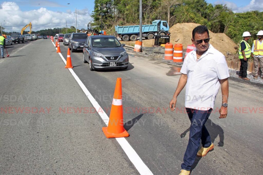 Minister of Works and Transport Rohan Sinanan inspects the site of land slippage along the Solomon Hochoy Highway near the Macaulay overpass in Claxton Bay. - Photo by Lincoln Holder 