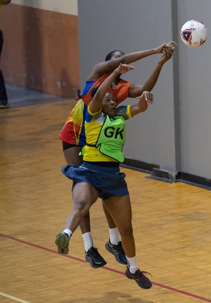 File photo of Defence Force goal keeper Camille Alexis, front, battles MIC Tigers' goal shooter Tiffany Gonzalez on the opening day of Courts All Sectors Netball League, at the Eastern Regional Indoor Arena, Tacarigua recently.  - Dennis Allen for @TTGameplan