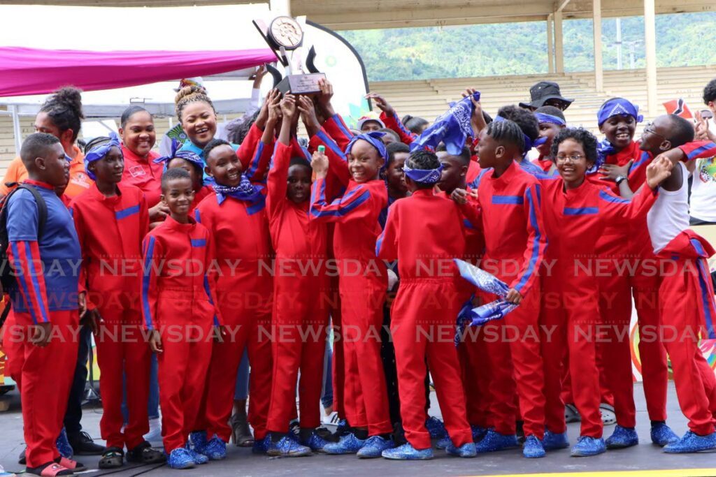 St. Margaret's Boys A.C. players lift the trophy after winning the primary school competition in the National Schools Panorama at the Queen's Park Savannah on Sunday. - Photo by Angelo Marcelle
