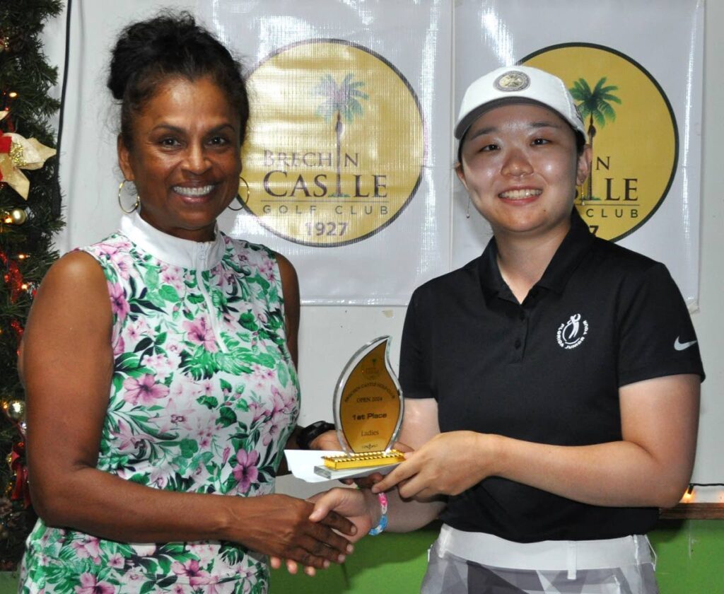 Ye Ji Lee, right, collects her women's trophy from BCGC secretary, Gail Rajack. - 