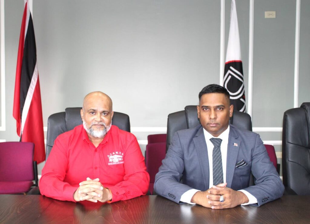 General Secretary of the All Trinidad General Workers' Trade Union, Rajindra Mohan, left, and Chief Personnel Officer Commander, Dr Daryl Dindial, right, at Dindial's office on Tuesday before the union accepted the four per cent wage increase for workers of the Sugarcane Feeds Centre.  - Photo courtesy the Office of the CPO 