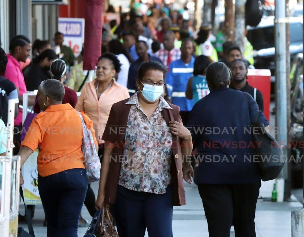 A woman wearing her mask in Port of Spain last week. Religious bodies have reintroduced covid19 measures at places of worship.  -  File photo by Ayanna Kinsale