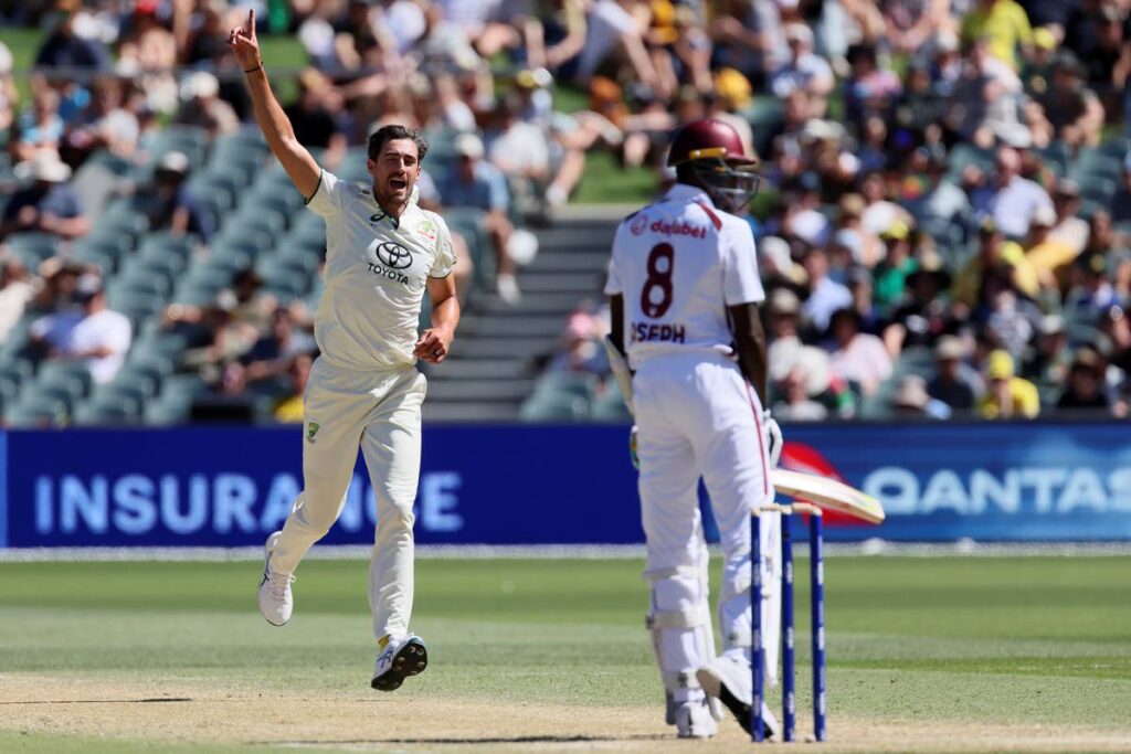 Australia's Mitchell Starc celebrates taking the wicket of West Indies' Alzarri Joseph, right, on the third day of the first Test match in Adelaide, Australia, on January 19. - AP PHOTO