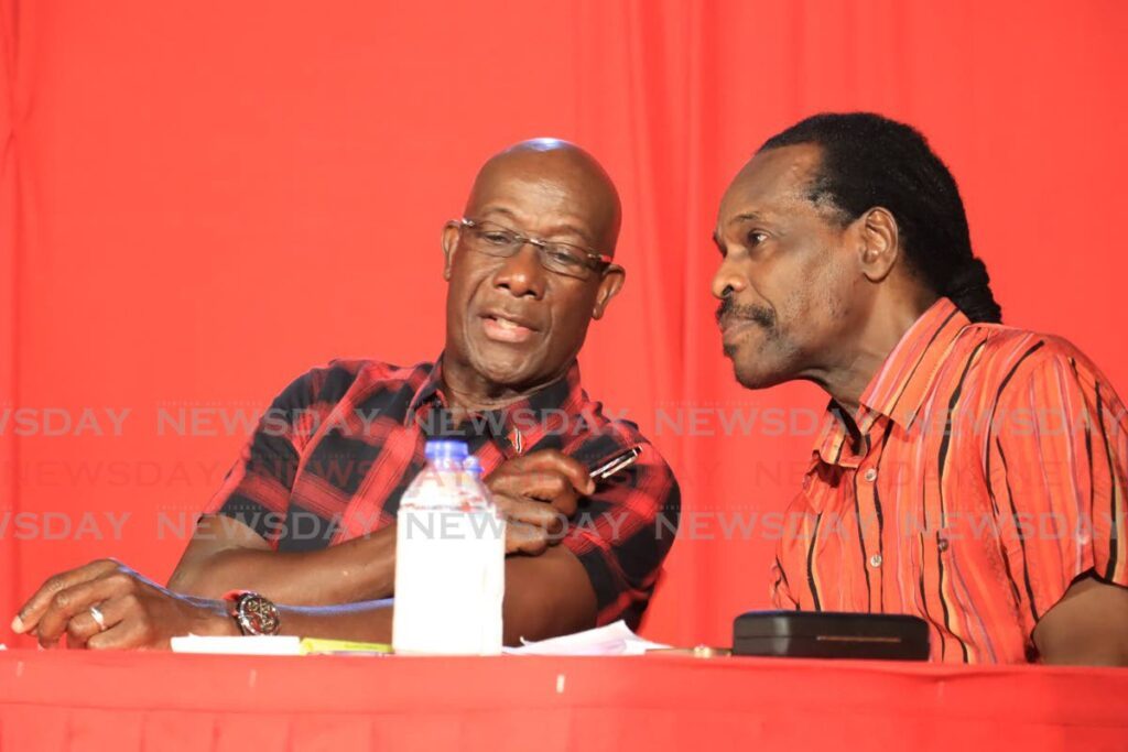 Prime Minister Dr Keith Rowley and National Security Minister Fitzgerald Hinds in discussion during a PNM meeting in San Juan on January 18. - Photo by Roger Jacob