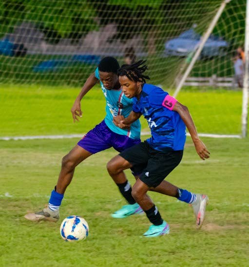 Athletic International Academy captain screens his Caledonia opponent in a NLCL Under-19 match recently.  - File photo