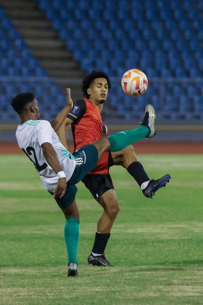 AC PoS Michel Poon-Angeron (R) challenges Prisons FC Jay-son Joseph for the ball during the Trinidad and Tobago Premier Football League match at the Hasely Crawford Stadium, on Friday night, in Port of Spain. AC PoS won 5-1. - Photo by Daniel Prentice 