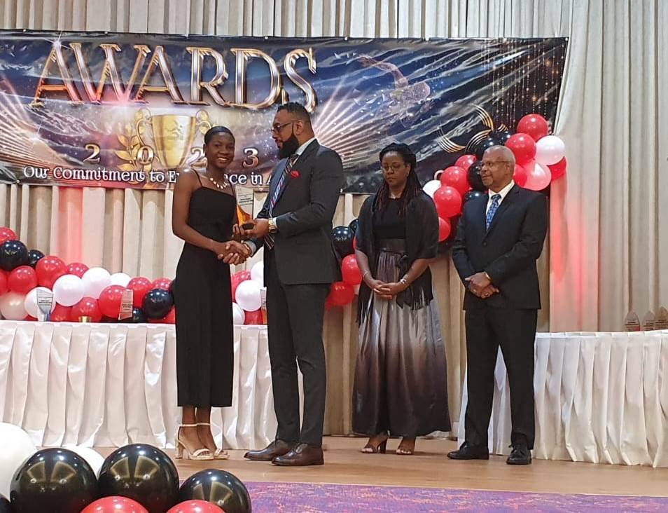 Janae De Gannes, left, collects the youth women's athlete of the year award from National Gas Company chairman Dr Joseph Khan. Looking on are National Association of Athletics Adminisrations (NAAA) president George Comissiong, right, and Ministry of Sport and Community Development deputy permanent secretary Beverly Reid-Samuel. - Photo courtesy the NAAA