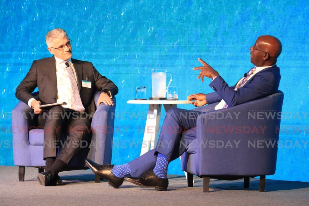 PM Dr Keith Rowley, right, speaks with Dr Thackwray Driver, president and CEO of the Energy Chamber at the TT Energy Conference on Monday at the Hyatt Regency, Port of Spain.  - Photo by Roger Jacob