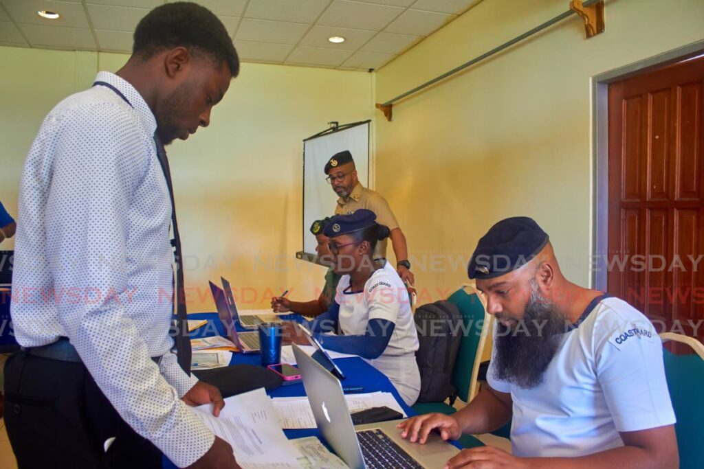 Defence Force personnel assist applicants during a recruitment drive on Monday at the Tobago Hospitality and Tourism Institute in Blenheim, Mt St George. - Photo by Jaydn Sebro