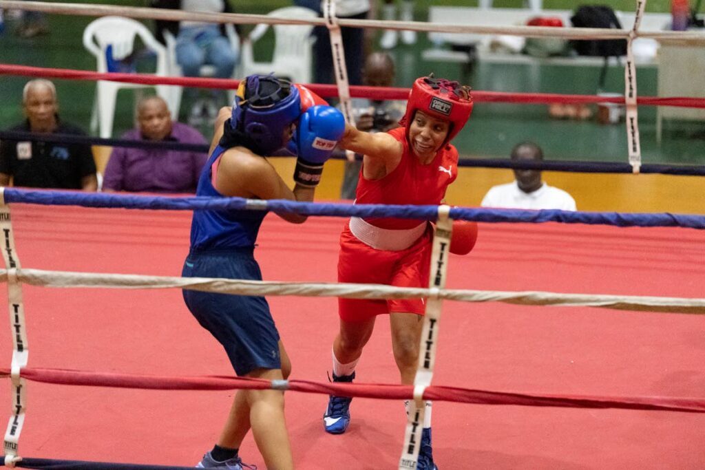 Golden Fist boxing Club's Tianna Guy (R) lands a punch against Siparia Boxing Gym's Alesha King during the elite female 63.5kg National Boxing Championships final, on Sunday, at the Southern Regional Indoor Sports Arena, Pleasantville. - Photo by Dennis Allen for @TTGameplan