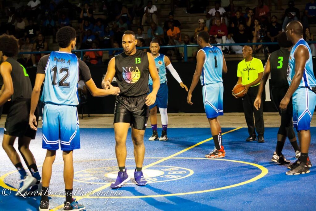 Players from New Chapter Academy (black) and Caracas City (blue) greet each other follwing their  Destiny Invitational Arima League game, on Friday, at the Princess Royal Basketball Court, Arima. - (Destiny Invitational Arima League)