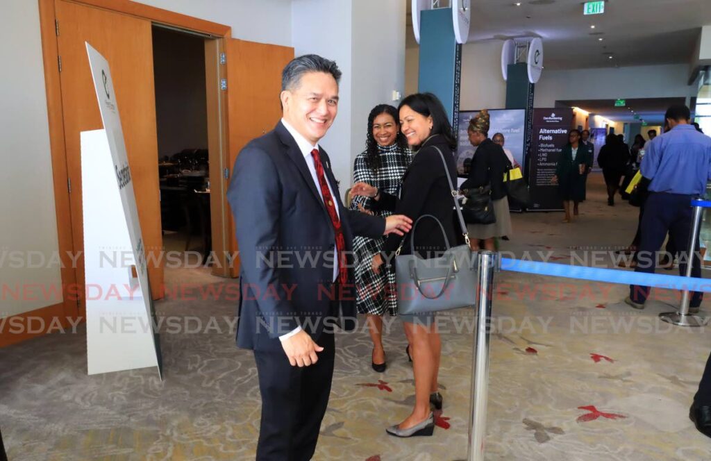 National Gas Company (NGC) Ltd president Mark Loquan greets two women at the energy conference at the Hyatt Regency in Port of Spain on January 22. Photo by Roger Jacob