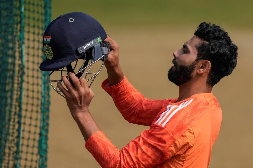 India's Ravindra Jadeja checks his helmet as he attends a practice session ahead of their first cricket Test match against England in Hyderabad, India on Wednesday. - AP PHOTO