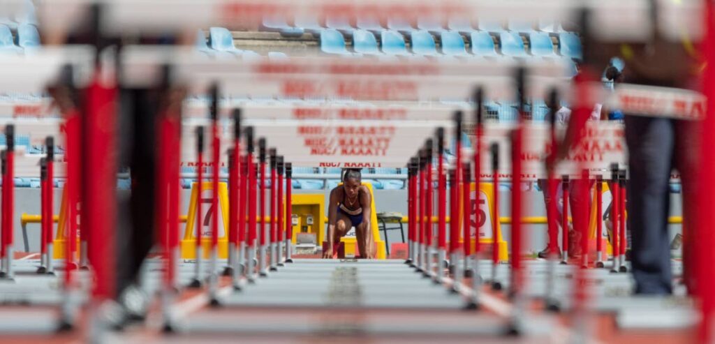 
 Kewes Gomes, of Holy Faith Convent, Couva, gets ready to compete in the girls' 17+ 100m hurdles , on Thursday, at the Secondary Schools Track and Field South Central Regionals, at the Hasely Crawford Stadium, Port of Spain. - Photo by Dennis Allen for @TTGameplan