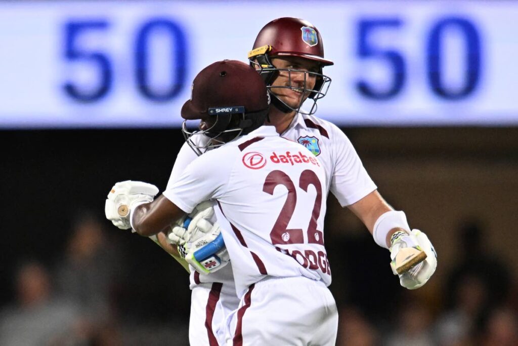 The West Indies' Joshua Da Silva (R) is congratulated by teammate Kavem Hodge after Da Dilva made 50 runs against Australia on the first day of the second Test in Brisbane, on Thursday. - AP PHOTO