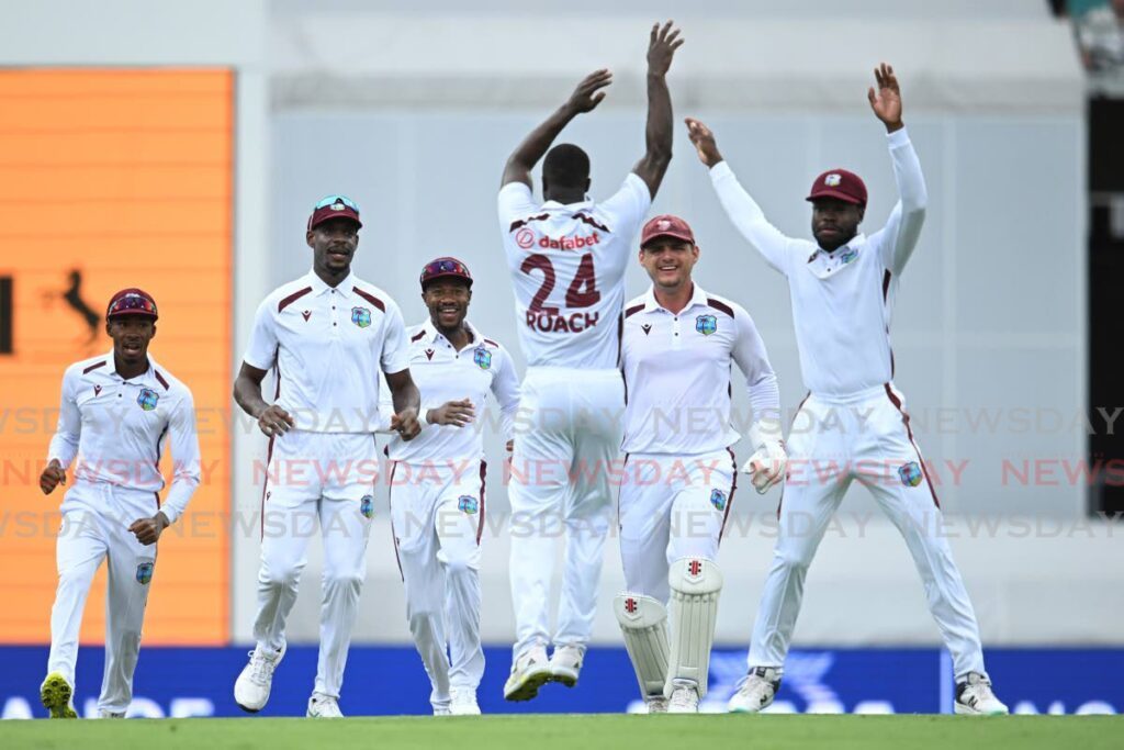 West Indies’ Kemar Roach, centre, celebrates with teammates after taking the wicket of Australia’s Cameron Green on the second day of their Test match in Brisbane, Friday. - AP