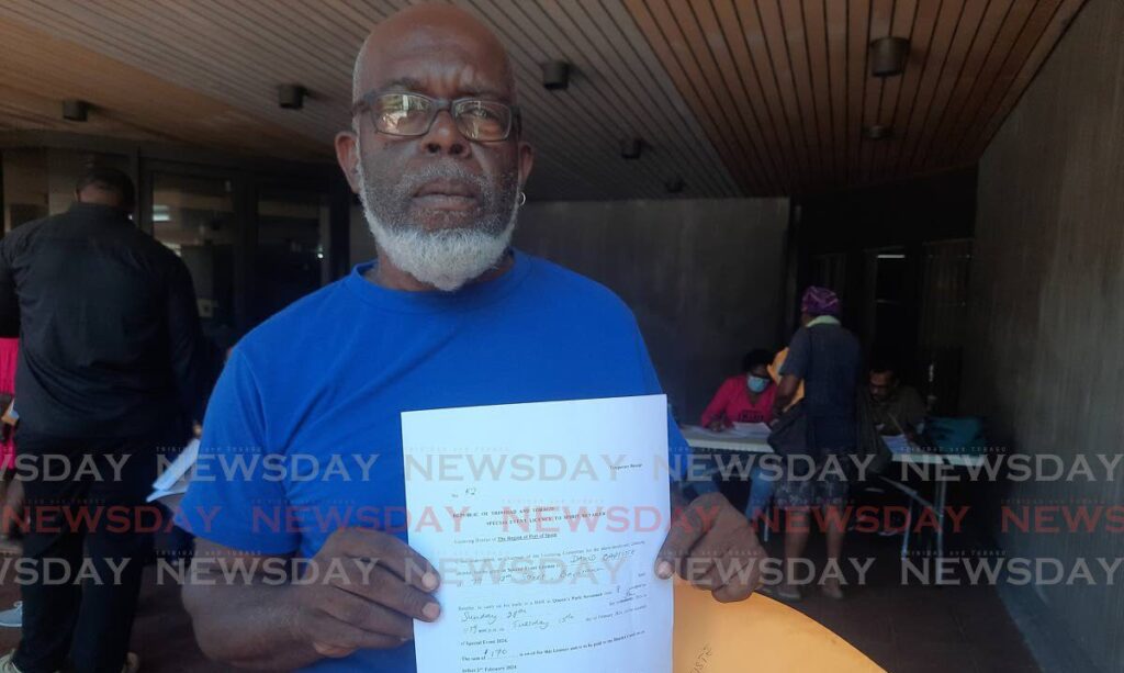 Carnival Entrepreneurs Association president David Baptiste after he received his licence to sell alcohol at the Queen's Park Savannah.  - Photo by Paula Lindo
