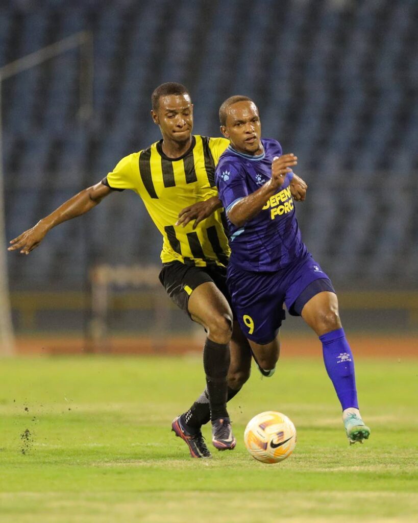  Defence Force FC Nathaniel Garcia (R) goes past Central FC defender Levin Caballero during the TT Premier Football League match at the Hasely Crawford Stadium, Port of Spain on Friday.  - Daniel Prentice