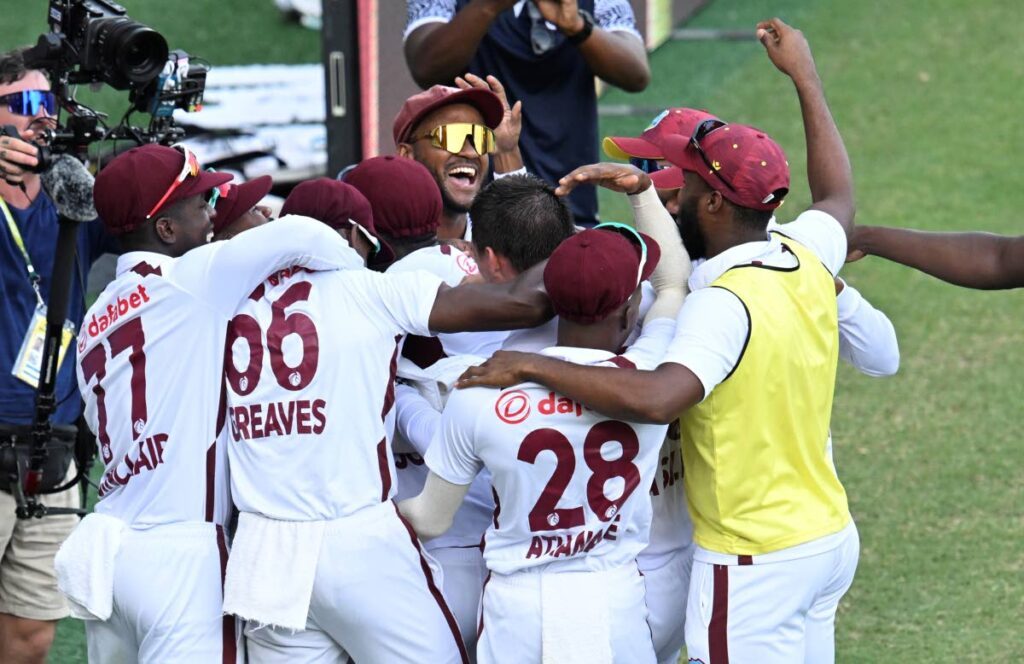 West Indies players celebrate after defeating Australia on the 4th day of their Test match in Brisbane on Sunday. - AP PHOTO