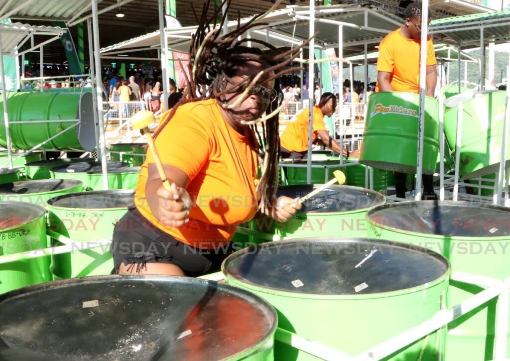 PAN GLORY: A Pan Elders Steel Orchestra member enjoys herself during the band’s performance of Come Out to Play at Panorama medium conventional bands semi-finals at Queen’s Park Savannah, Port of Spain, on Sunday. - Photo by Ayanna Kinsale