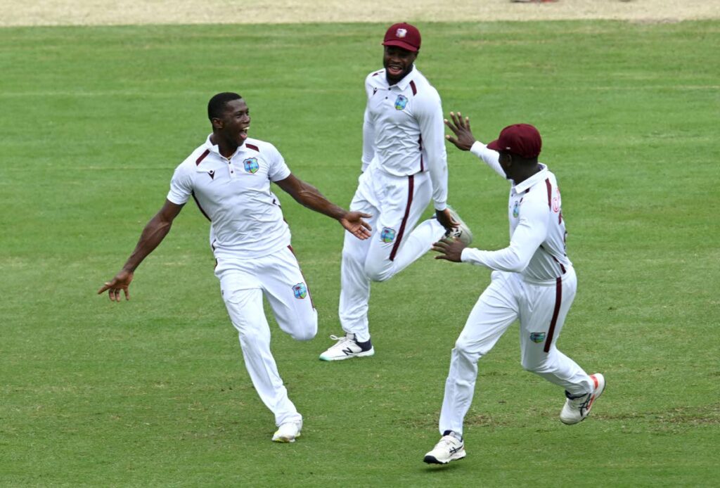 West Indies' Shamar Joseph, left, celebrates taking the wicket of Australia's Travis Head on the 4th day of their cricket Test match in Brisbane, Sunday. - ap