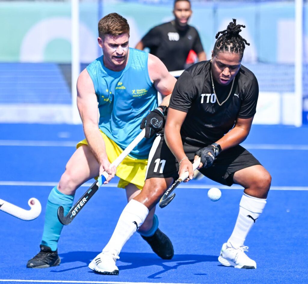 Trinidad and Tobago's Tariq Marcano, right, in action against Australia in the Hockey 5s World Cup group stage in Oman. - 