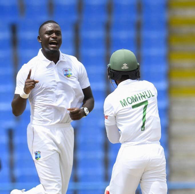 In this June 16, 2022 file photo, West Indies' Jayden Seales (L) celebrates the dismissal of Mominul Haque (R) of Bangladesh during the first day of the first Test at the Sir Vivian Richards Cricket Stadium in North Sound, Antigua.  - 