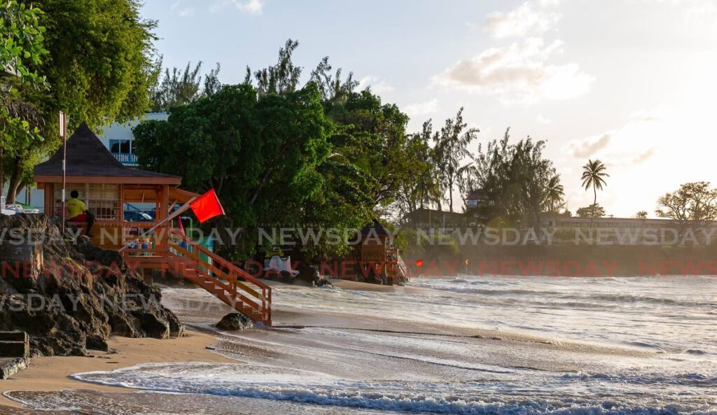 Red flags at the lifeguard booths at Store Bay. - File photo