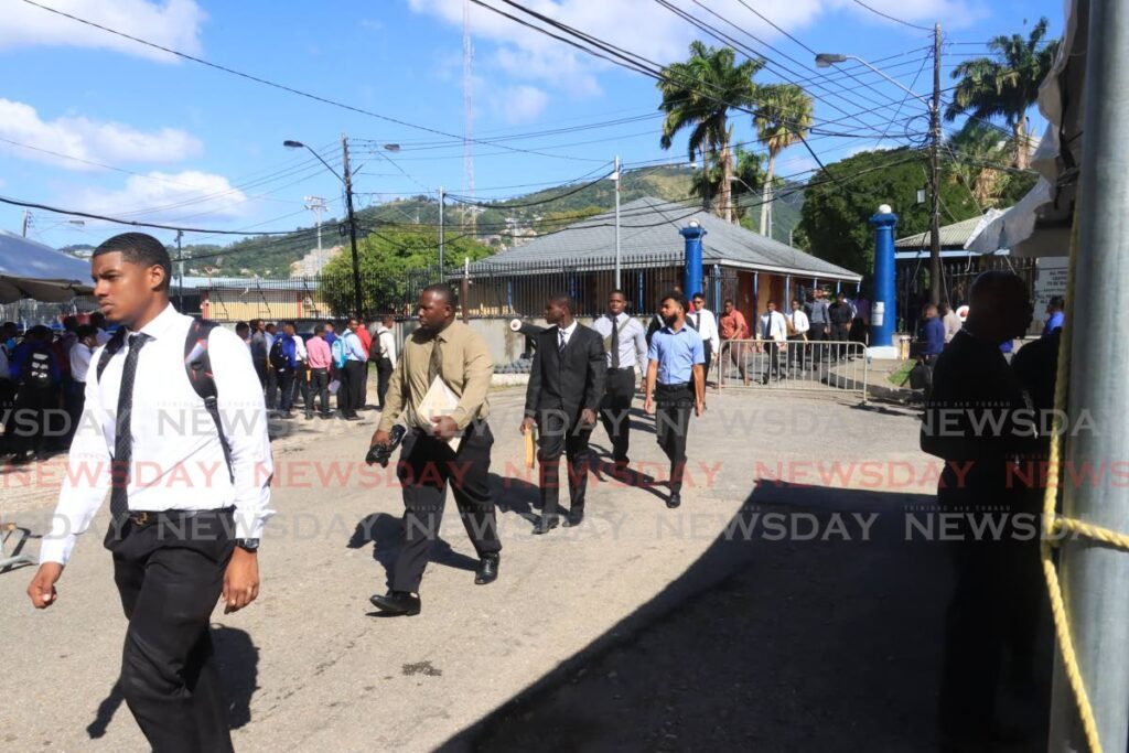 Men seeking careers in the police file into the Police Training Academy in St James in January. - File photo by Roger Jacob
