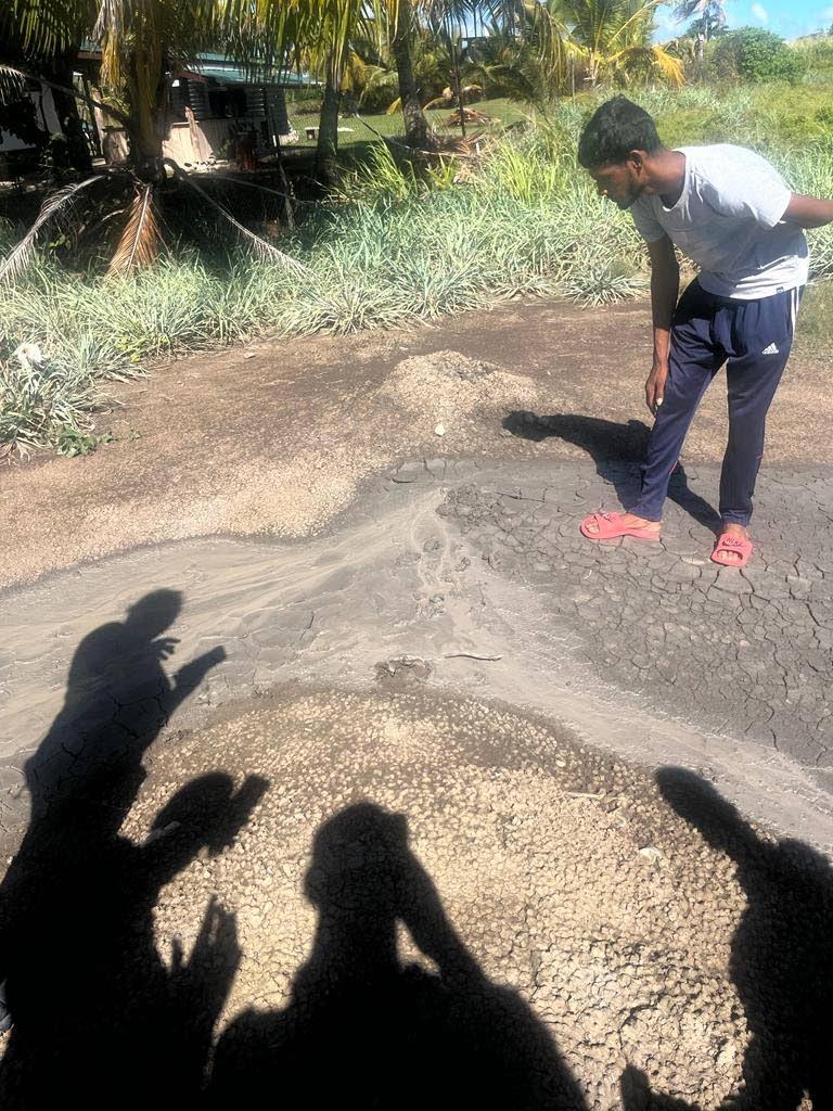 A villager takes a closer look at one of the vents of the mud volcano at Cascadoux Trace, Mayaro during a site visit by officials of Mayaro/Rio Claro Regional Corporation on January 12.  - Photo courtesy Raymond Cozier