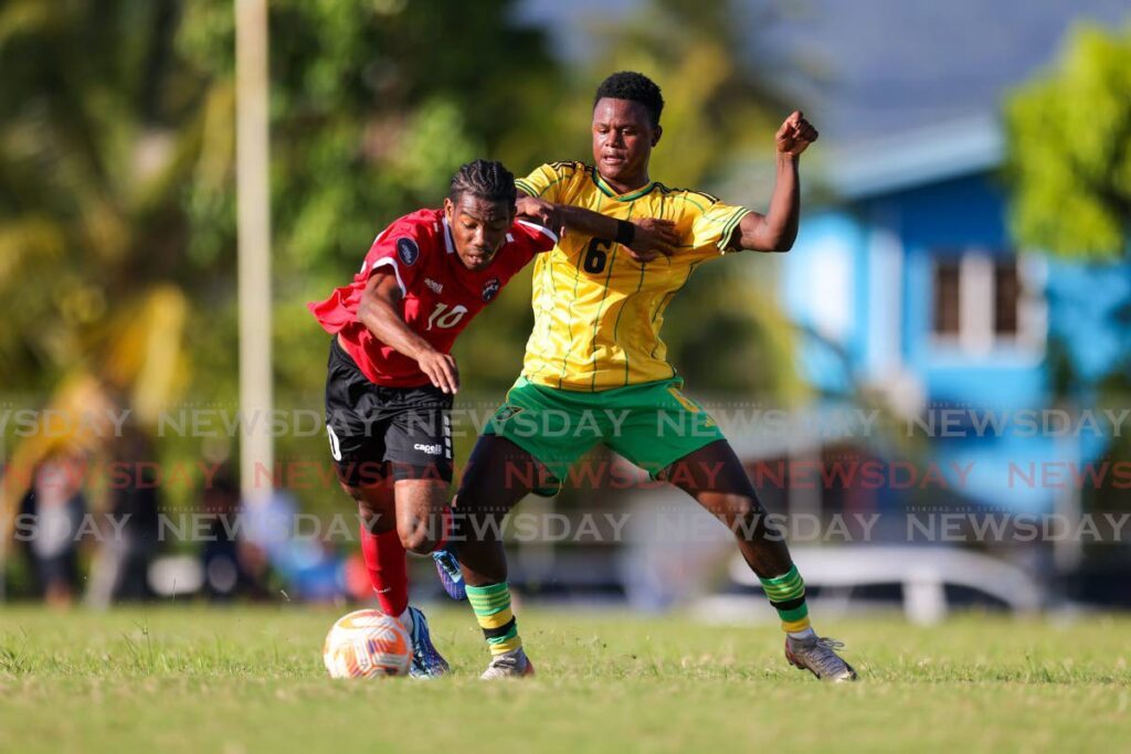 TT U20 player Lindell Sween, left, moves past Jamaica’s Denzel McKenzie during a practice match at the University of TT O’meara, Arima. - File photo by Daniel Prentice
