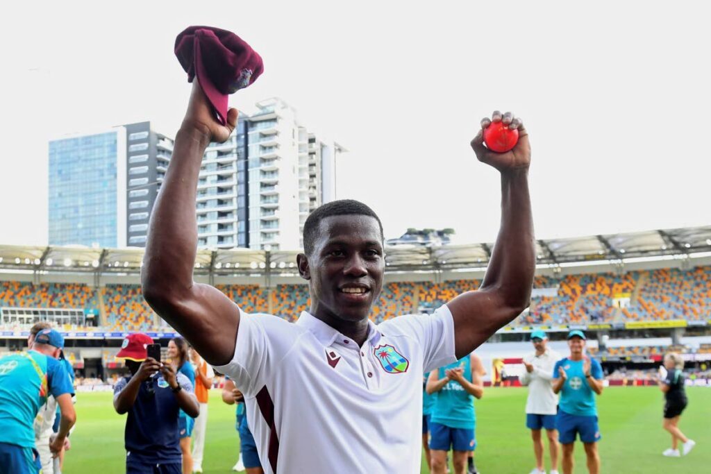 West Indies' Shamar Joseph raises the ball after taking 7 wickets in his team's defeat of Australia on the 4th day of their Test match in Brisbane, on January 28, 2024.  - AP