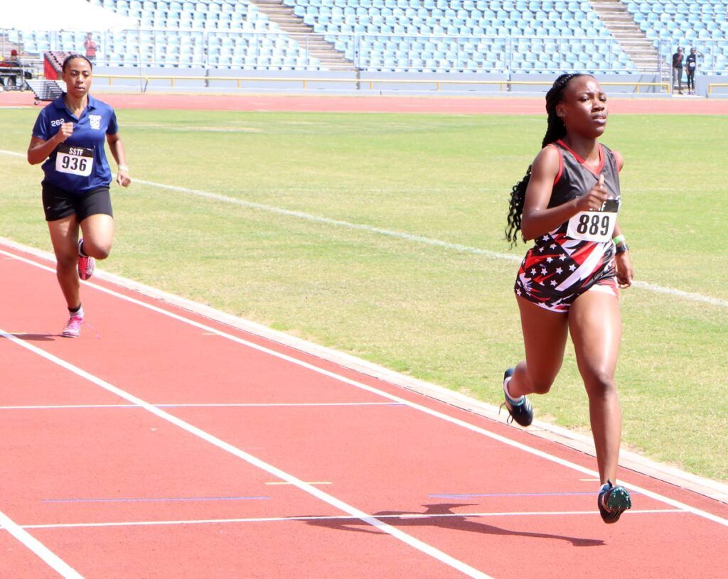 Mya Phillips of Bishop Anstey High School on her way to victory in a girls Under-17  800m race at the Secondary Schools Track and Field North Regional Championships, Hasely Crawford Stadium, Port of Spain on Wednesday. Behind her is Andrine Sylvester of Bishop Anstey High School East.  - Angelo Marcelle