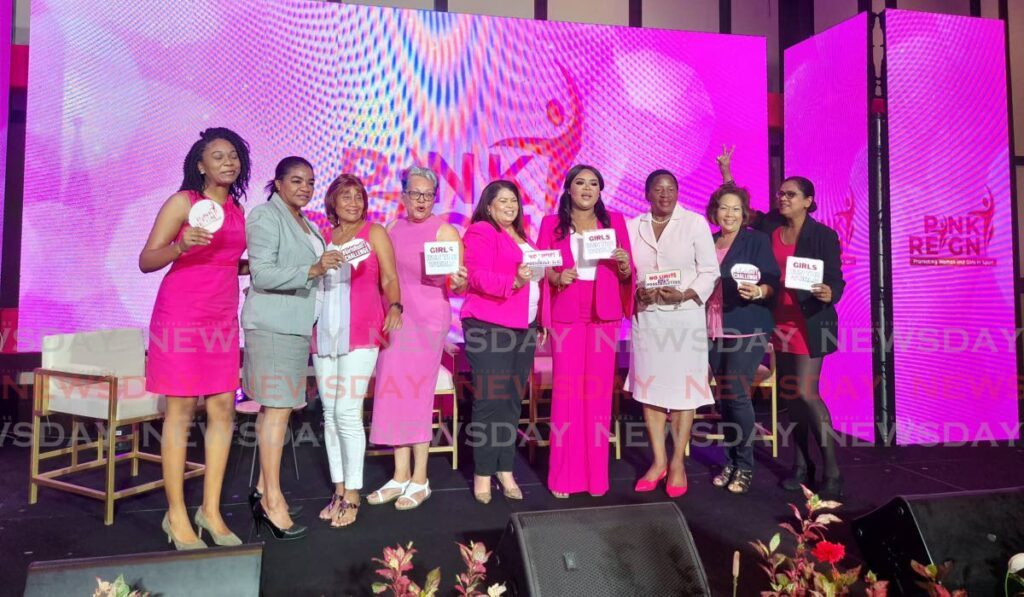 Sport and Community Development Minister Shamfa Cudjoe-Lewis, centre, and Planning and Development Minister Penelope Beckles, second from right, with Team Poon members at the launch of the Pink Reign Campaign. - Roneil Walcott