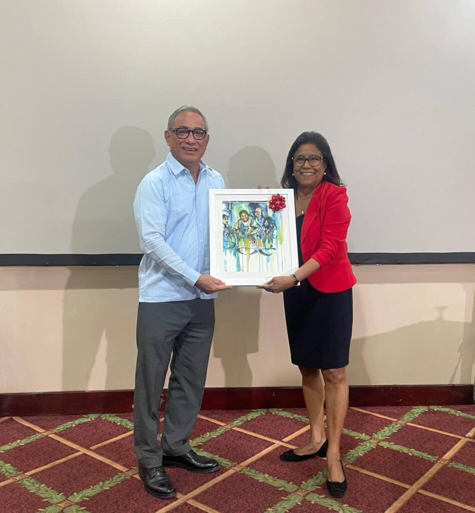Trade and Industry Minister, Paula Gopee-Scoon, presents Prime Minister of Belize, John Briceno, with a painting by a local TT artist following the Doing Business in Belize seminar on Wednesday.
Photo courtesy MTI - 