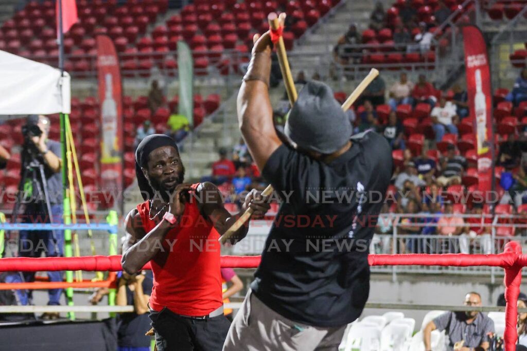 Oniel Odle, right, battled for the upper hand against Terrance Marcano during the National Carnival Commission Stickfighting Semifinals at the Diego Martin Sporting Complex on January 31 with Odle winning.  - Photo by Daniel Prentice