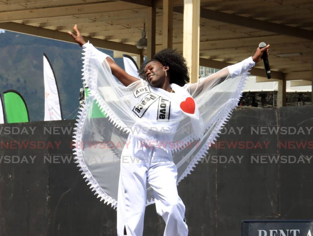 WITH PURPOSE: Nataki Thompson of Scarborough Secondary School during her winning performance of Your Purpose at the National Junior Calypso Monarch finals at the Queen's Park Savannah, Port of Spain on Monday.  - ROGER JACOB