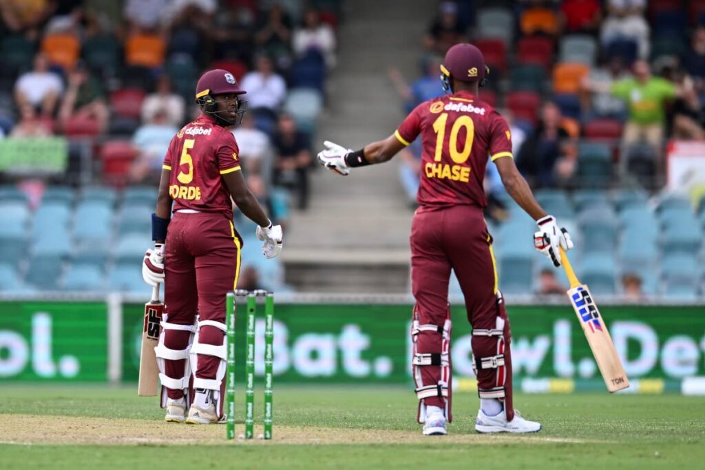 Matthew Forde (L) of the West Indies argues with teammate Roston Chase during the third one day international against Australia at the Manuka Oval in Canberra, Australia, on Tuesday. - AP PHOTO