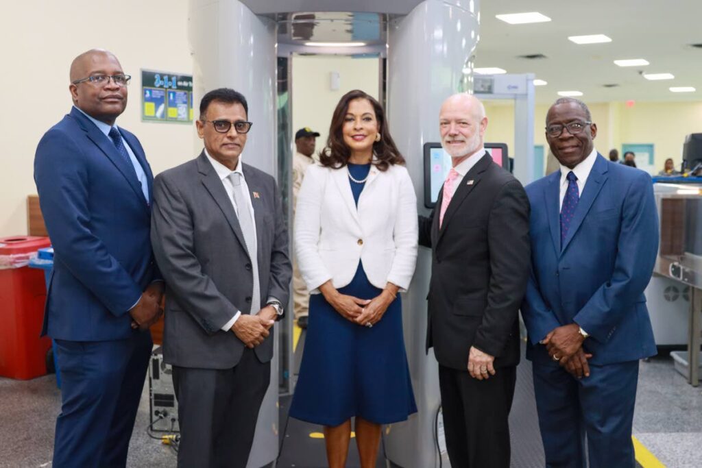 From left, Airports Authority General Manager Hayden Newton, Works and Transport Minister Rohan Sinanan, US Ambassador Candace Bond, TSA Assistant Administrator for International Operations Gary Renfrow, and Chairman of the Civil Aviation Authority Thomas Lawrence, at the handing-over ceremony of four bomb-detection devices from the US to the Airports Authority.  - Photo courtesy US Embassy