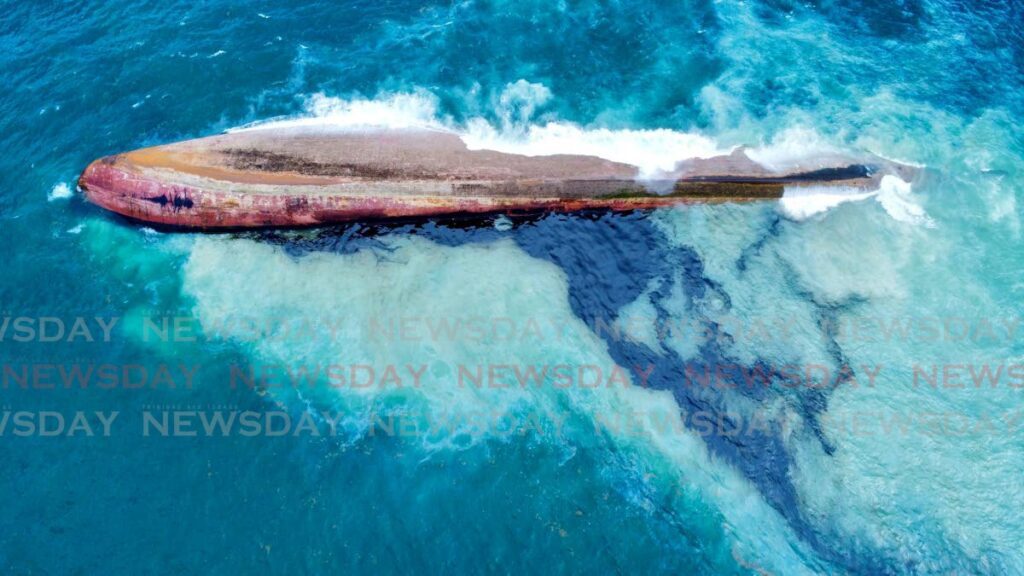 An overturned boat is leaking oil 200m off Cove, Tobago. - Photo by Jaydn Sebro