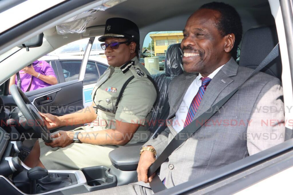 JOY RIDE: Minister of National Security Fitzgerald Hinds was all smiles as he and Police Commissioner Erla Harewood-Christopher sits in one of the new vehicles handed over to the police and defence force at VMCOTT, Beetham Highway on February 9. - Photo by Angelo Marcelle
