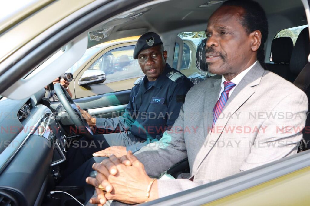 National Security Minister Fitzgerald Hinds and Chief of Defence Staff Vice Air Marshall Darryl Daniel check out one of the new military vans during a handover ceremony on February 9 at Vmcott, Beetham. - Angelo Marcelle