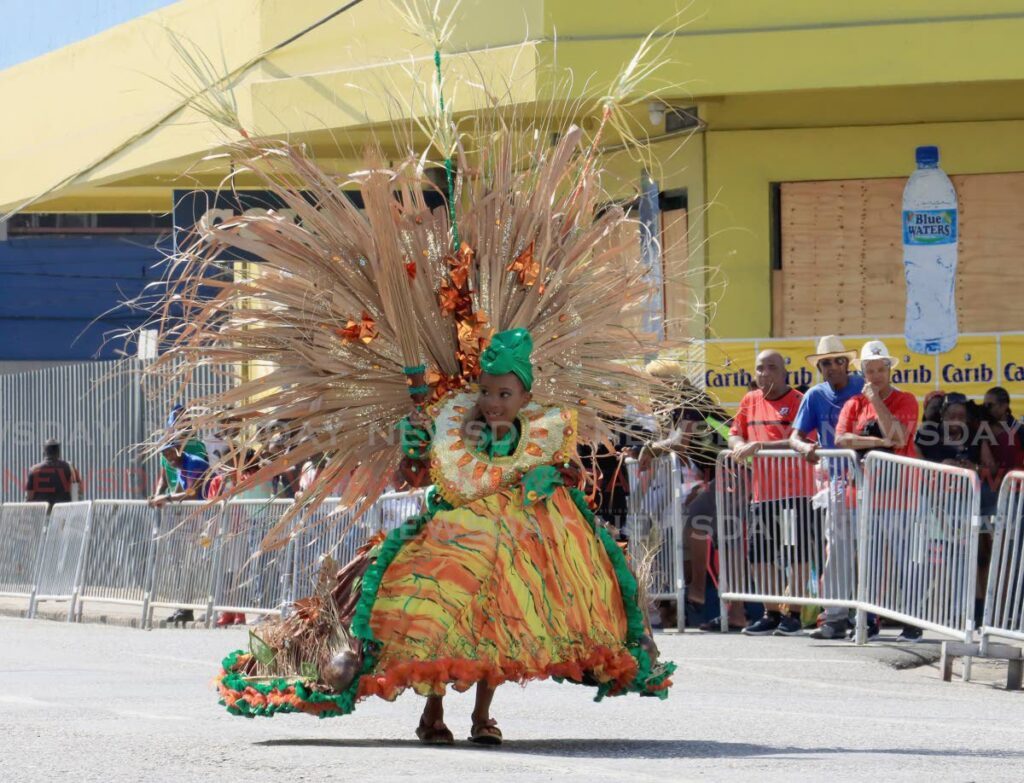 Farinha McKenzie, 6, playing Madame Cocoyea in the individual historical mas character of the Junior Parade of the Band, South Quay, Port of Spain. - Photo by Roger Jacob